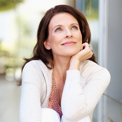 Lovely mature woman looking away in thought